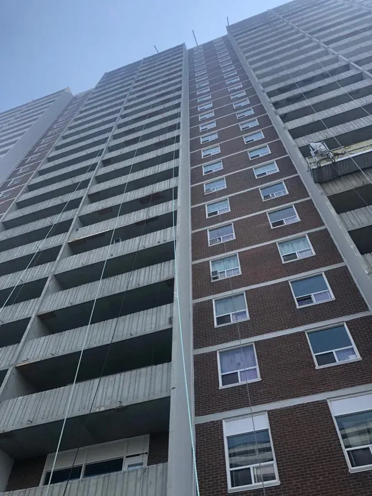 Balcony restoration crew at work on a high-rise